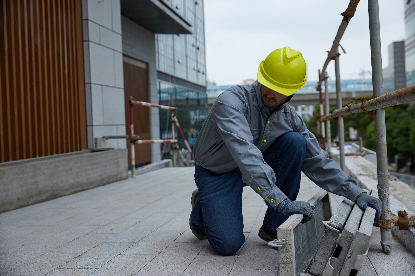 A worker in an industrial setting wearing durable FR jeans