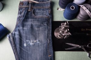 FR jeans showing signs of wear and tear in a workshop